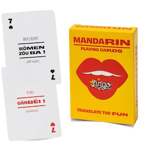 May include: A yellow box of Mandarin Playing Cards with a red lip graphic and the text Lingo, Translate the Fun. Two white playing cards are shown, one with the text Women Zou Ba and the other with Ganbei, featuring Chinese characters and English.