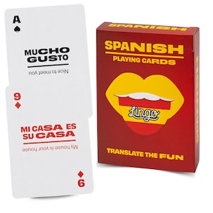 May include: A deck of Spanish playing cards in a red box with yellow text and a lip graphic, alongside two white cards featuring the phrases Mucho Gusto and Mi Casa Es Su Casa with their English translations printed in black and red ink.