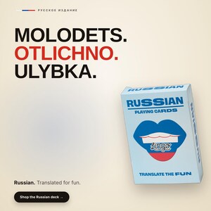 May include: A deck of Russian playing cards in a light blue box featuring a blue, white, and red lip graphic with the text Lingo. The box displays the words RUSSIAN PLAYING CARDS and TRANSLATE THE FUN. The background includes the text MOLODETS. OTLICHNO. ULYBKA.