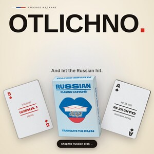 May include: A deck of Russian playing cards in a light blue box featuring a blue, white, and red lip graphic. The box displays the text RUSSIAN PLAYING CARDS and TRANSLATE THE FUN. Two cards are shown with Russian and English text and symbols.