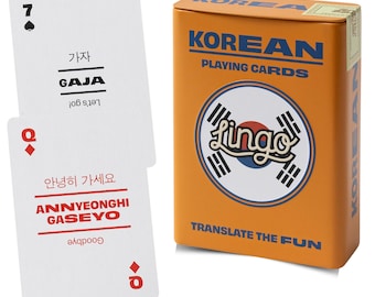 May include: A deck of Korean playing cards in an orange tin box with blue text reading KOREAN PLAYING CARDS and TRANSLATE THE FUN. Two white cards are displayed: one with a black 7 and the text GAJA, and one with a red Q and ANNYEONGHI GASEYO.