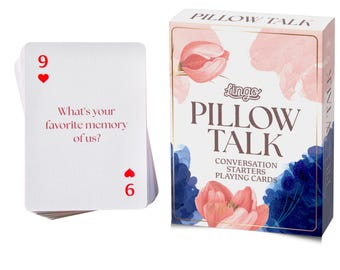 May include: A deck of Pillow Talk conversation starter playing cards in a rectangular box with pink and blue floral watercolor illustrations. One card is displayed showing the number 9, a red heart, and the text: What's your favorite memory of us?