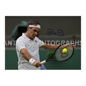 May include: Image of a tennis player in a white polo shirt and headband, holding a tennis racket with a yellow ball. The image includes a signature and the text "ANT AUTOGRAPHS".
