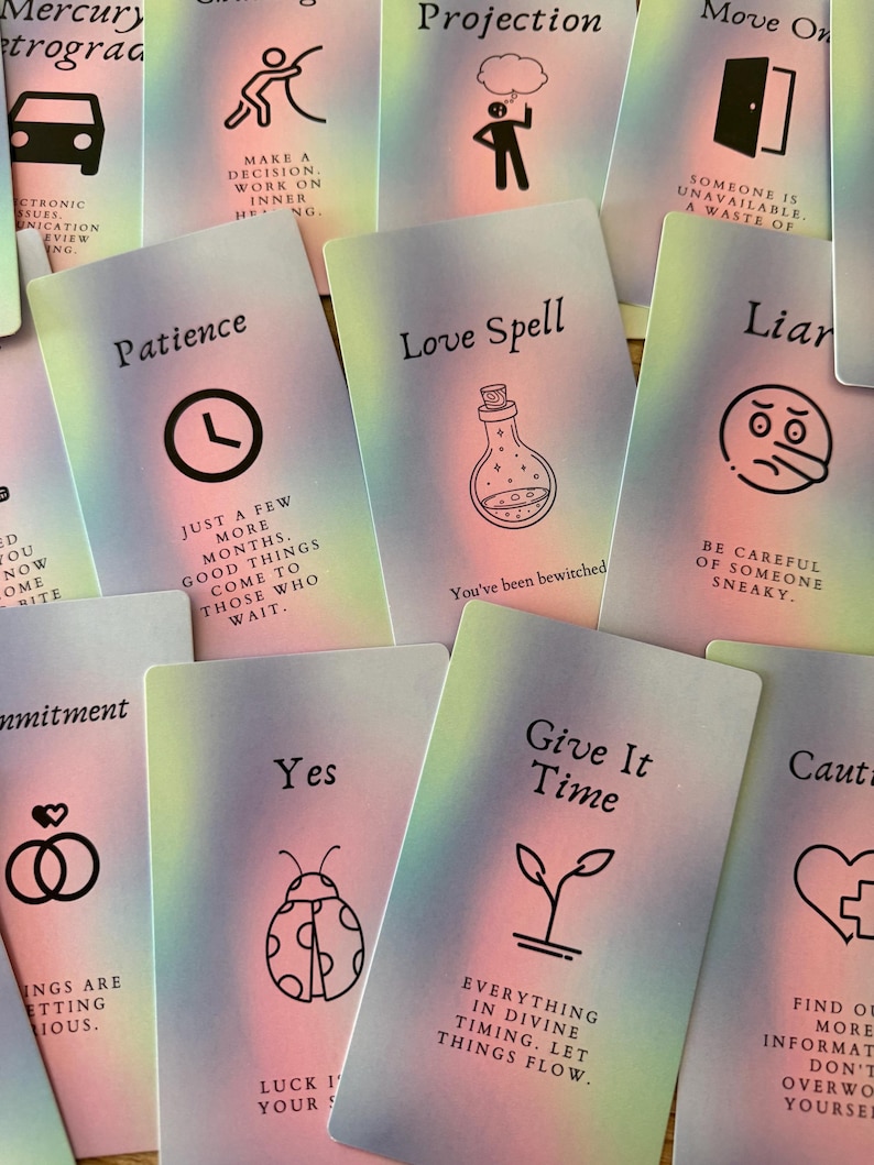 May include: A collection of oracle cards with pastel gradient backgrounds. Each card features a unique illustration and text, including a clock for "Patience" and a potion bottle for "Love Spell". Other cards say "Yes" and "Give it Time".
