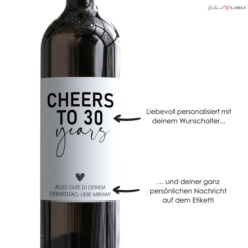 May include: A white wine bottle label with black text that reads "Cheers to 30 years". The label also includes a small black heart and the text "Alles Gute zu deinem Geburtstag, liebe Miriam!"