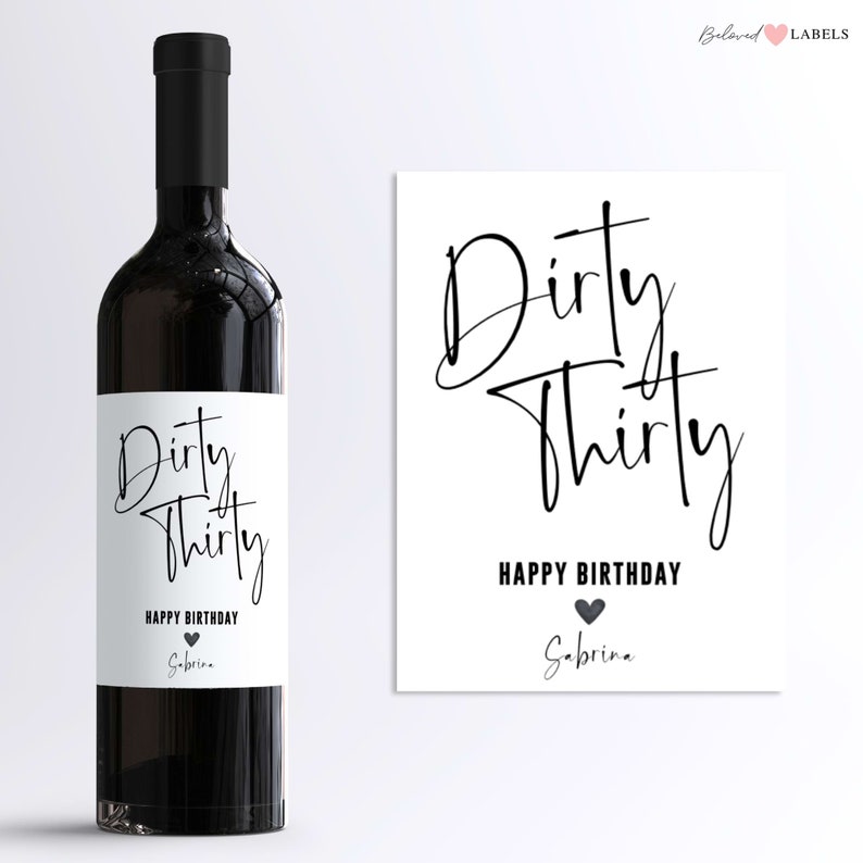 May include: A white wine bottle label with black text that reads "Dirty Thirty Happy Birthday Sabrina". A black heart is next to the text "Happy Birthday".