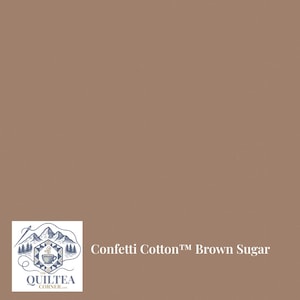 May include: A solid brown fabric labeled "Confetti Cotton Brown Sugar" with a logo in the lower left corner. The logo features a mountain range, trees, and a teacup.