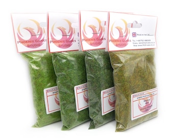 May include: Four bags of static grass for model railroading or miniature gaming. The bags are labeled with the company name "Phoenix Games Studio" and the type of grass: "Winter 4mm Static Grass 300g".