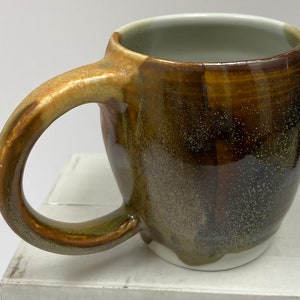 ceramic, multi-color, handmade, 12 oz mug in overlapping triangles of orange, grey, brown, white, 3.5&quot; tall, 3&quot; diameter