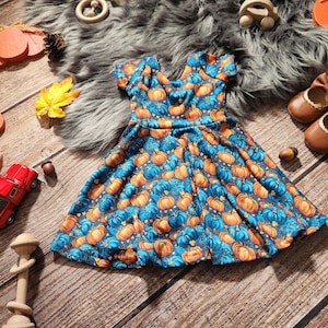 pumpkin patch party dresses when your outfit matches the pumpkins >> @evaastavrouu is wearing the on my mind orange strapless mini dress #fallfashion #falloutfitinspo #fallaesthetic #pumpkinpatch #falloutfit #minidress #straplessdresses #fallstyle