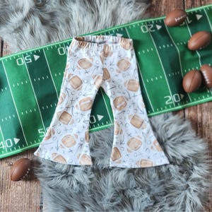 Football bellbottoms, Baby girl football outfit with bow, game day football shirt, outfit for toddlers, football spirit shirt, baby bodysuit