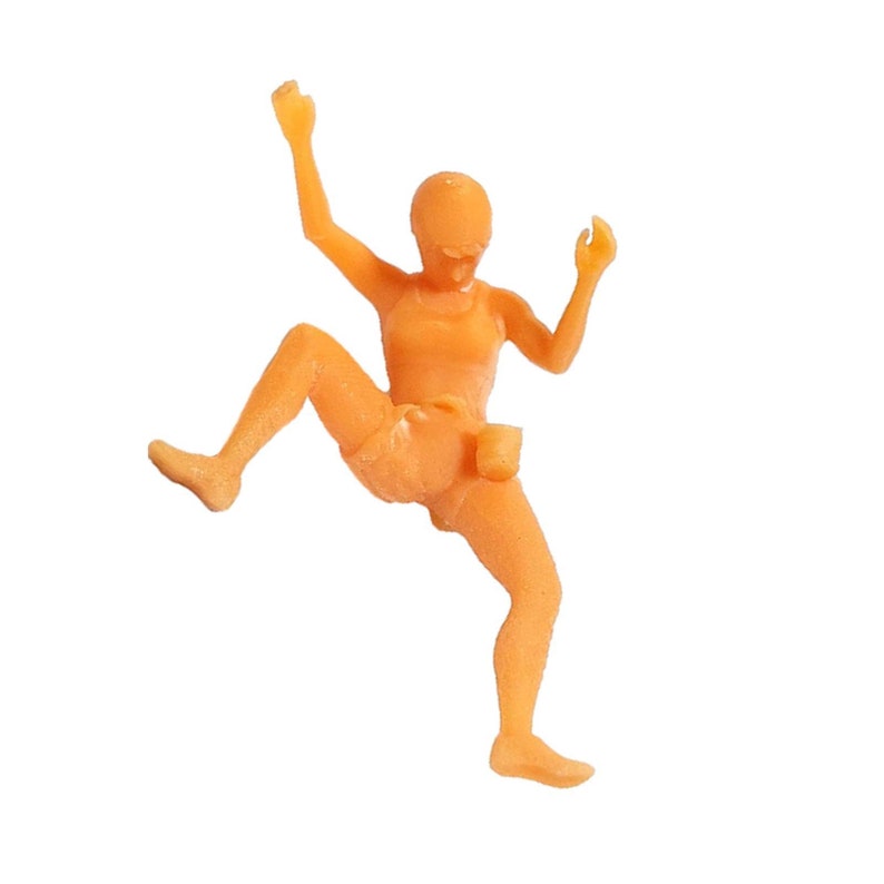May include: Orange plastic figurine of a person in a running pose with arms raised.