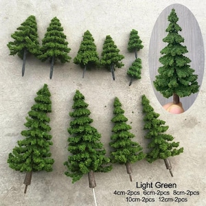 Peut inclure: Ensemble de petits sapins artificiels vert clair. Les arbres varient en taille, mesurant 4 cm, 6 cm, 8 cm, 10 cm et 12 cm. Chaque arbre a un tronc brun et est destiné aux travaux manuels ou à la création de maquettes.