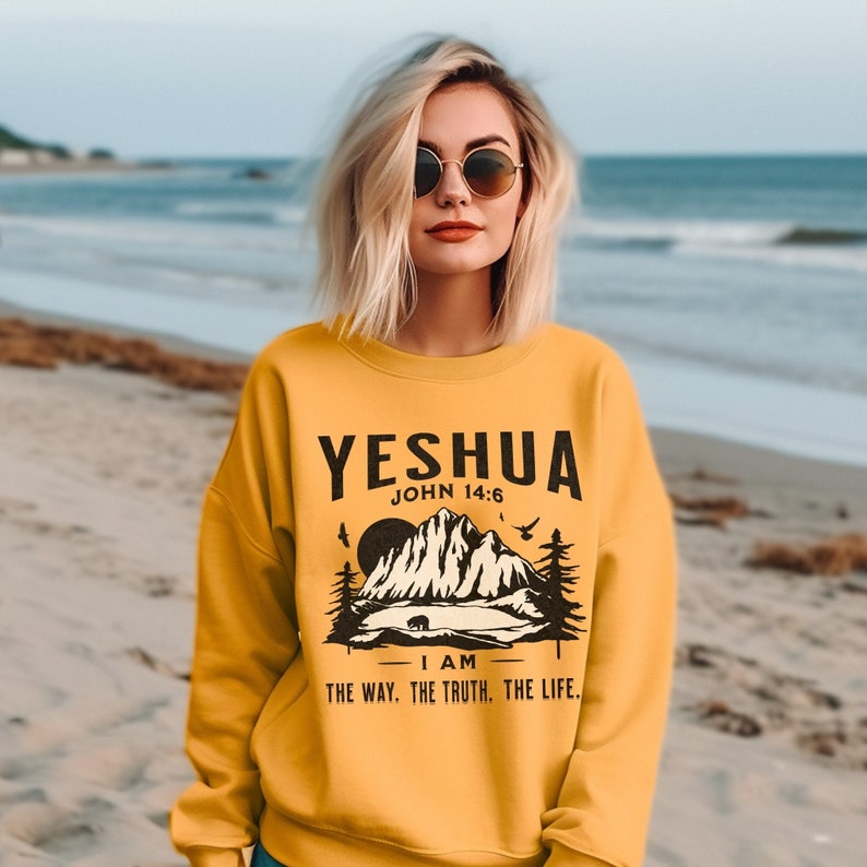 May include: Yellow sweatshirt with a black graphic of a mountain range and the text "YESHUA JOHN 14:6 I AM THE WAY. THE TRUTH. THE LIFE."