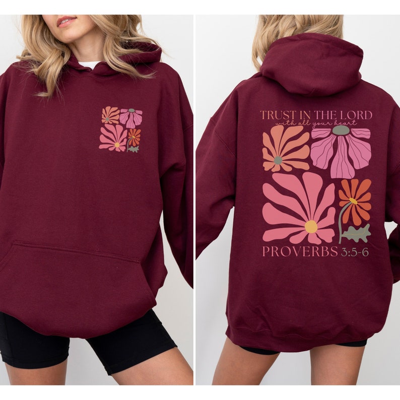 May include: Burgundy hoodie with a floral design and the text "TRUST IN THE LORD with all your heart" and "PROVERBS 3:5-6" on the back.
