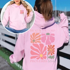 May include: Pink hoodie with a floral design and the text "TRUST IN THE LORD with all your heart PROVERBS 3:5-6"