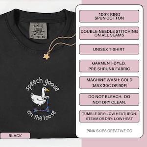 May include: Black unisex t-shirt with the embroidered phrase "speech goose on the loose" and a graphic of a goose on a scooter. The shirt has a crew neck and short sleeves. A gold star pendant hangs from a gold chain.