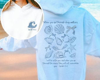 Puede incluir: Sudadera azul claro con un diseño de conchas marinas y el texto "When you go through deep waters I will be with you and when you go through the rivers, they will not overwhelm you - Isaiah 43:2".