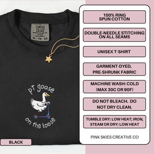 May include: Black unisex t-shirt with an embroidered design of a goose on a scooter, with the text "pt goose on the loose". The shirt is made of 100% ring-spun cotton and has double-needle stitching.