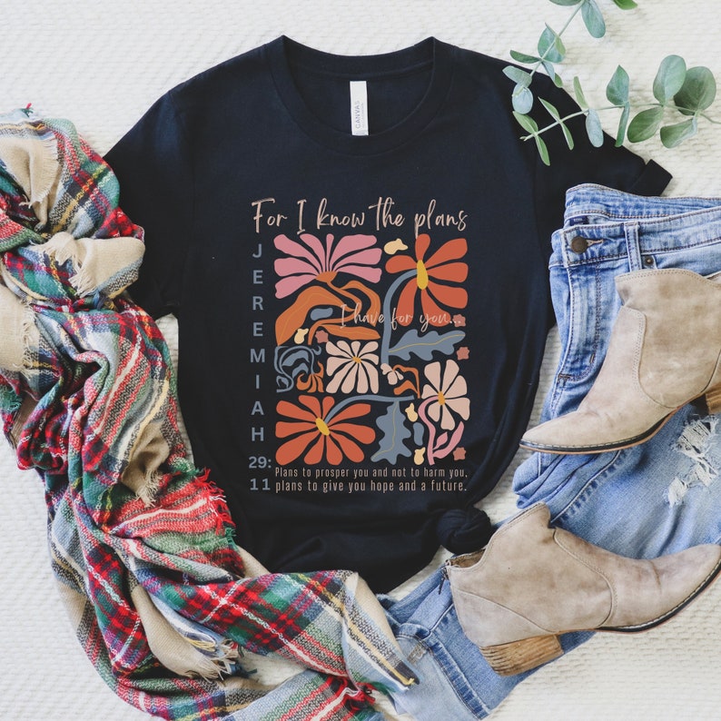 May include: Black t-shirt with a floral design and the text "For I know the plans I have for you" with the scripture reference Jeremiah 29:11. The text reads "Plans to prosper you and not to harm you, plans to give you hope and a future."