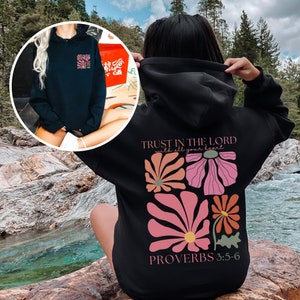 May include: Black hoodie with a floral design and the text "TRUST IN THE LORD with all your heart" and "PROVERBS 3:5-6".