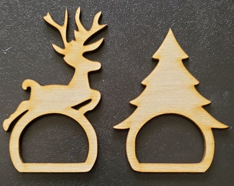 May include: Two wooden napkin rings, one shaped like a reindeer and the other shaped like a Christmas tree.