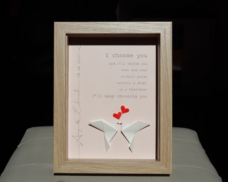 May include: A framed print with a pink background and white origami birds. The print features the text "I choose you and I'll choose you over and over without pause without a doubt in a heartbeat I'll keep choosing you".