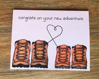 Wedding or engagement card, “Congrats on your new adventure,” with two pairs of hiking boots