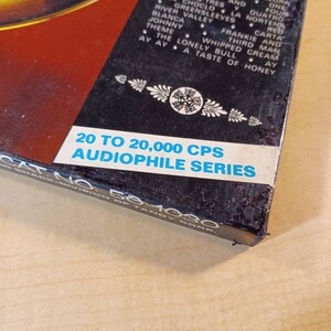 May include: A black box with a white label that reads "20 to 20,000 CPS AUDIOPHILE SERIES" and "CAT NO. 50-1080" in white text. The box has a red and black background with a list of song titles in white text.