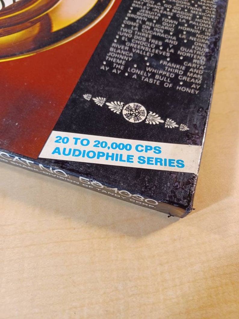 May include: A black box with a white label that reads "20 to 20,000 CPS AUDIOPHILE SERIES" and "CAT NO. 50-1080" in white text. The box has a red and black background with a list of song titles in white text.