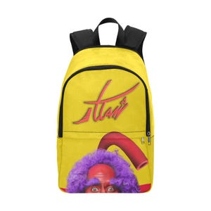 May include: Yellow backpack with a red and pink cartoon character with purple hair and a red and pink worm. The backpack has the word "Tami" written in red on the front.