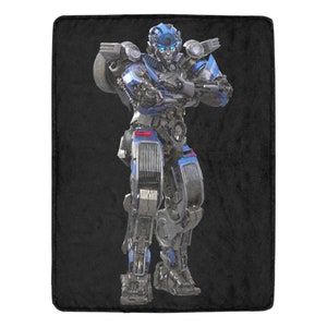 May include: A blue and silver robot with a black background. The robot has a human-like face with blue eyes and a black mouth. The robot is standing with its arms crossed.