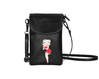 May include: Black leather crossbody phone bag with a cartoon image of a woman in a red dress.