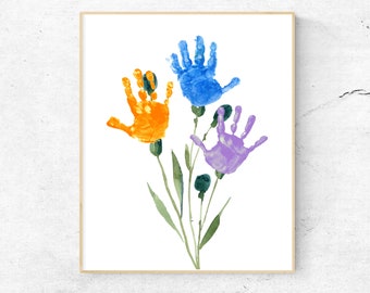 May include: A framed print of a handprint art piece featuring three handprints in the shape of flowers. The flowers are blue, orange, and purple. The handprints are surrounded by green stems and leaves.