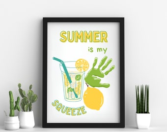 May include: A white framed print with the text "SUMMER is my SQUEEZE" in yellow and green. The print features a handprint, a glass of lemonade, and a lemon.