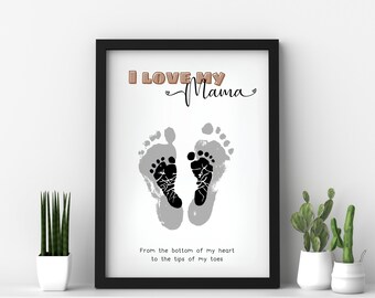 May include: A framed print featuring a black and white footprint design. The print reads "I LOVE MY Mama" in brown lettering and "From the bottom of my heart to the tips of my toes" in black lettering.