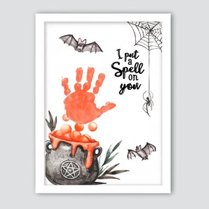 May include: A framed Halloween-themed art print featuring a watercolor illustration. The artwork includes a cauldron, a handprint, bats, a spider web, and the text "I put a Spell on you". The color palette includes orange, black, and gray.