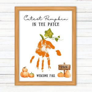 May include: A printable sign featuring an orange handprint shaped like a pumpkin with a green vine and leaves. The sign reads "Cutest Pumpkin in the Patch" and "Welcome Fall" with a small wooden sign saying "2024" and three small pumpkins.