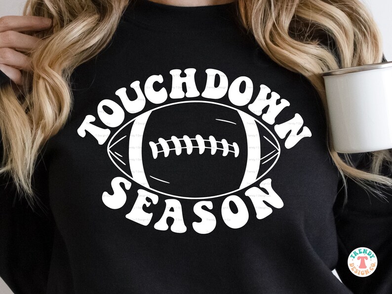 May include: Black sweatshirt with white text that reads "Touchdown Season" and a white outline of a football.