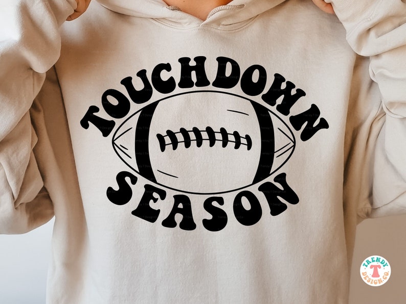 May include: A white hoodie with a black graphic design that says "Touchdown Season" with a football in the middle.