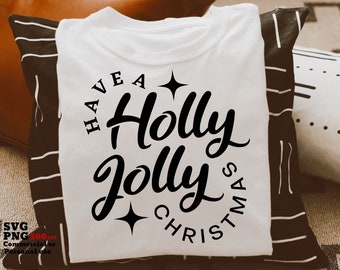May include: White t-shirt with a black design that says "Have a Holly Jolly Christmas" in a circle with stars.