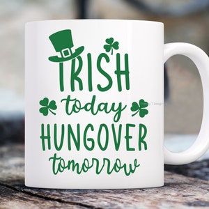 May include: White ceramic mug with a green shamrock design and the text "Irish today, hungover tomorrow".