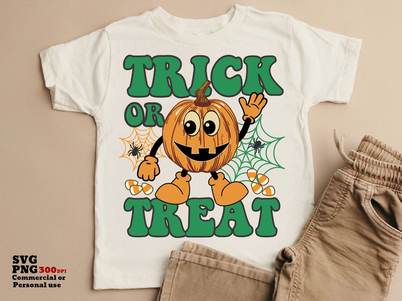 May include: White t-shirt with a green "Trick or Treat" graphic featuring a smiling pumpkin with a spiderweb behind it.