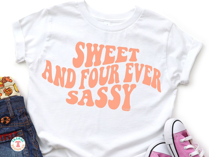 May include: White t-shirt with the text "Sweet and Four Ever Sassy" in pink, retro-style lettering.