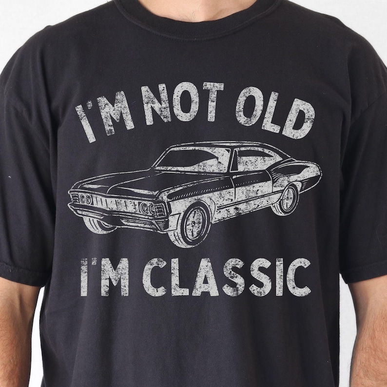 May include: Black t-shirt with a vintage-style graphic of a classic car and the text "I'm not old I'm classic".