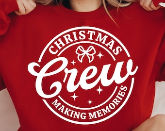 May include: Red sweatshirt with a white circle design that says "Christmas Crew Making Memories" with a white bow and stars inside the circle.