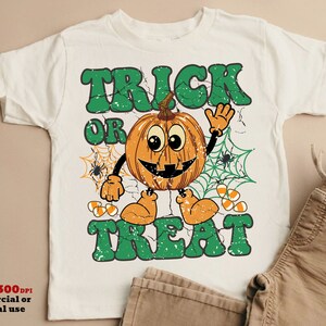 May include: White t-shirt with a green "Trick or Treat" graphic featuring a smiling pumpkin with candy corn and spiderwebs.