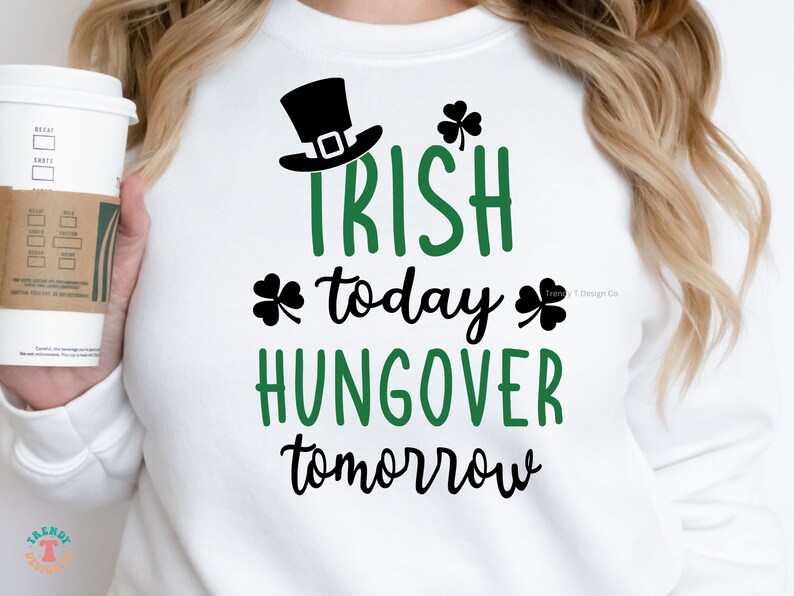 May include: White sweatshirt with black and green text that reads "Irish today, hangover tomorrow". A shamrock graphic is on either side of the text. A black leprechaun hat is above the text.