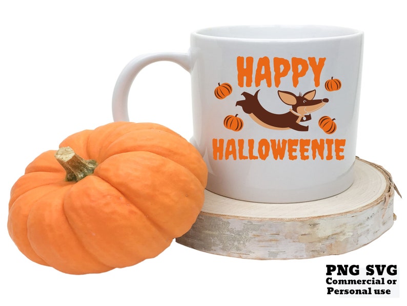 May include: White ceramic coffee mug with a brown dachshund dog wearing a pumpkin hat and the text "Happy Halloweenie" in orange letters. The mug is sitting on a wooden coaster.