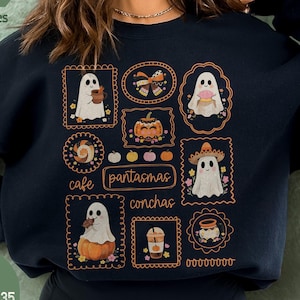 May include: Black sweatshirt featuring a collection of framed illustrations with ghost characters, pumpkins, and the words "cafe pantasmas conchas." The sweatshirt has the text "Mind & Harmony Gifts" on the side.